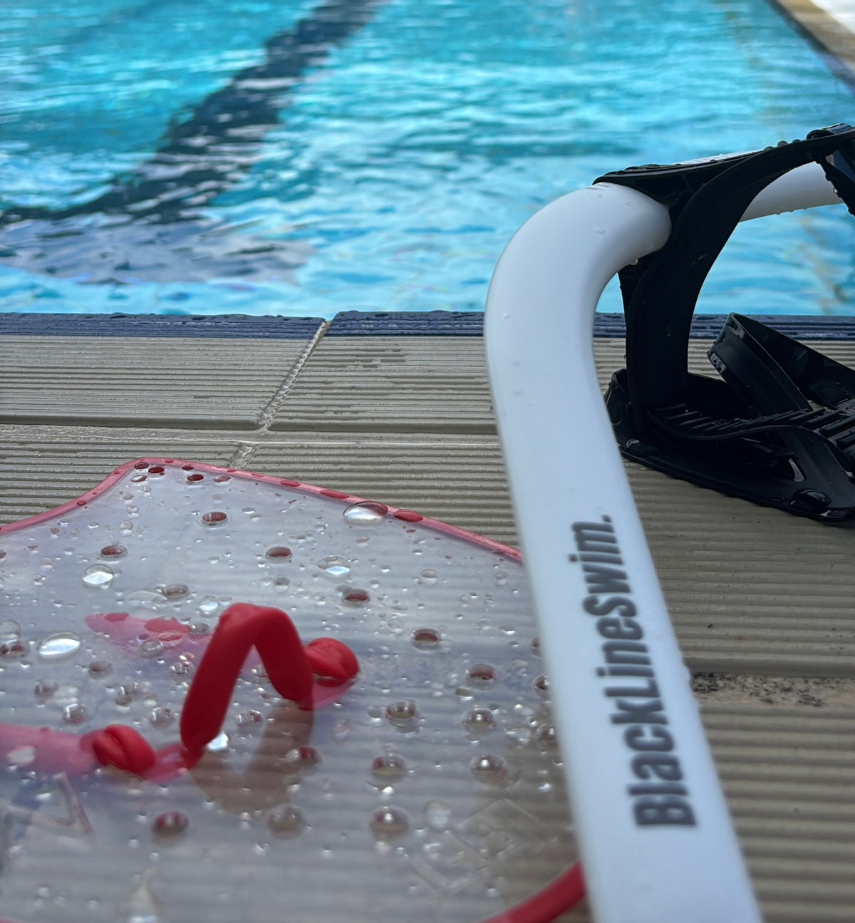 Swimmer training open water with the Hypoxic Snorkel and Vélocité Paddles